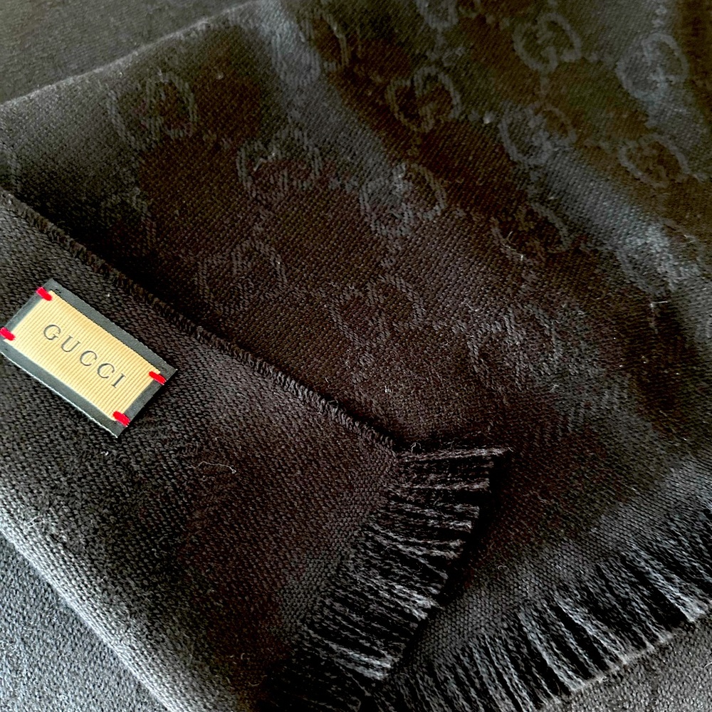 Black wool jacquard scarf features the GC pattern. Fringe trim .size 13x8W 70.9L